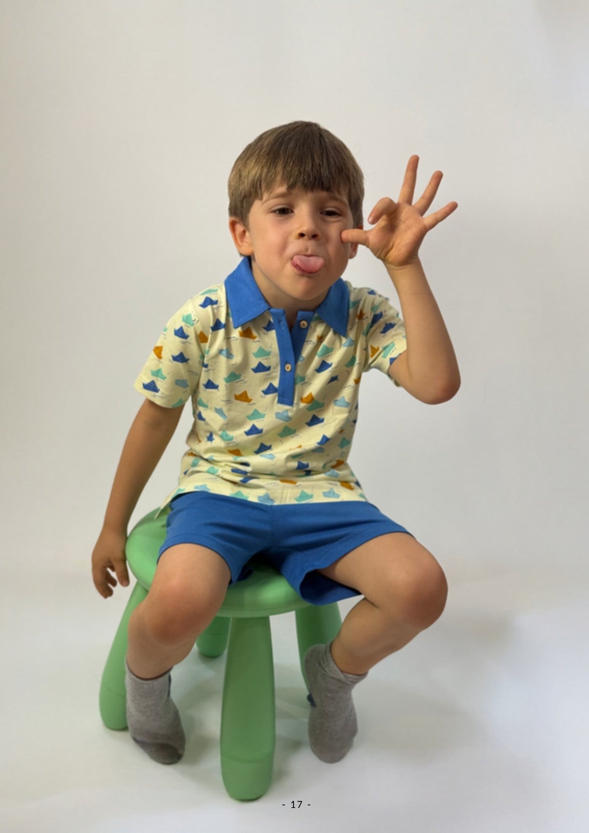 Boy wearing an Ola! Otter organic cotton polo t-shirt and shorts